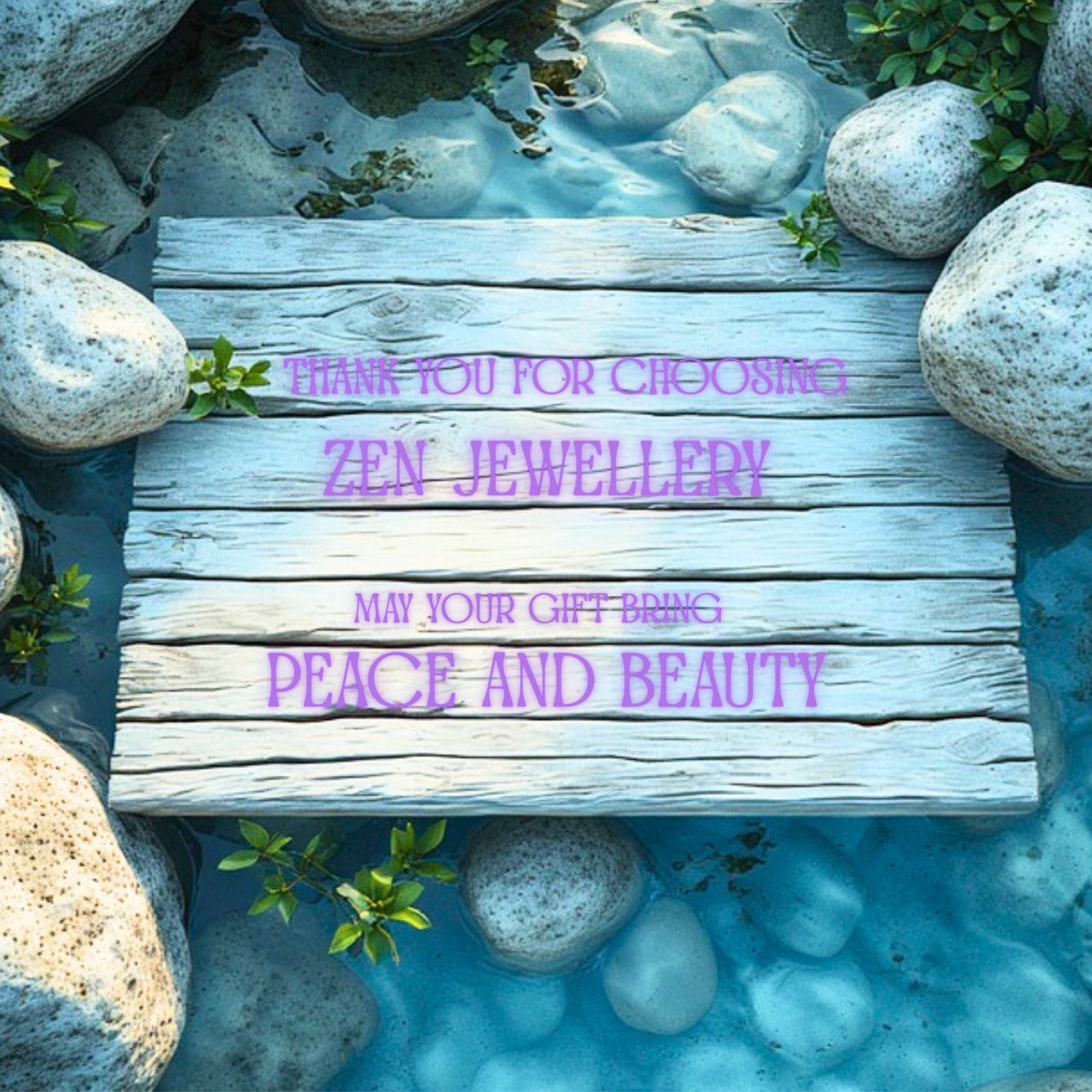 A square wooden plaque with engraved text reading 'THANK YOU FOR CHOOSING ZEN JEWELLERY MAY YOUR GIFT BRING PEACE AND BEAUTY' placed over a stone bridge in shallow blue water surrounded by rocks and green plants.