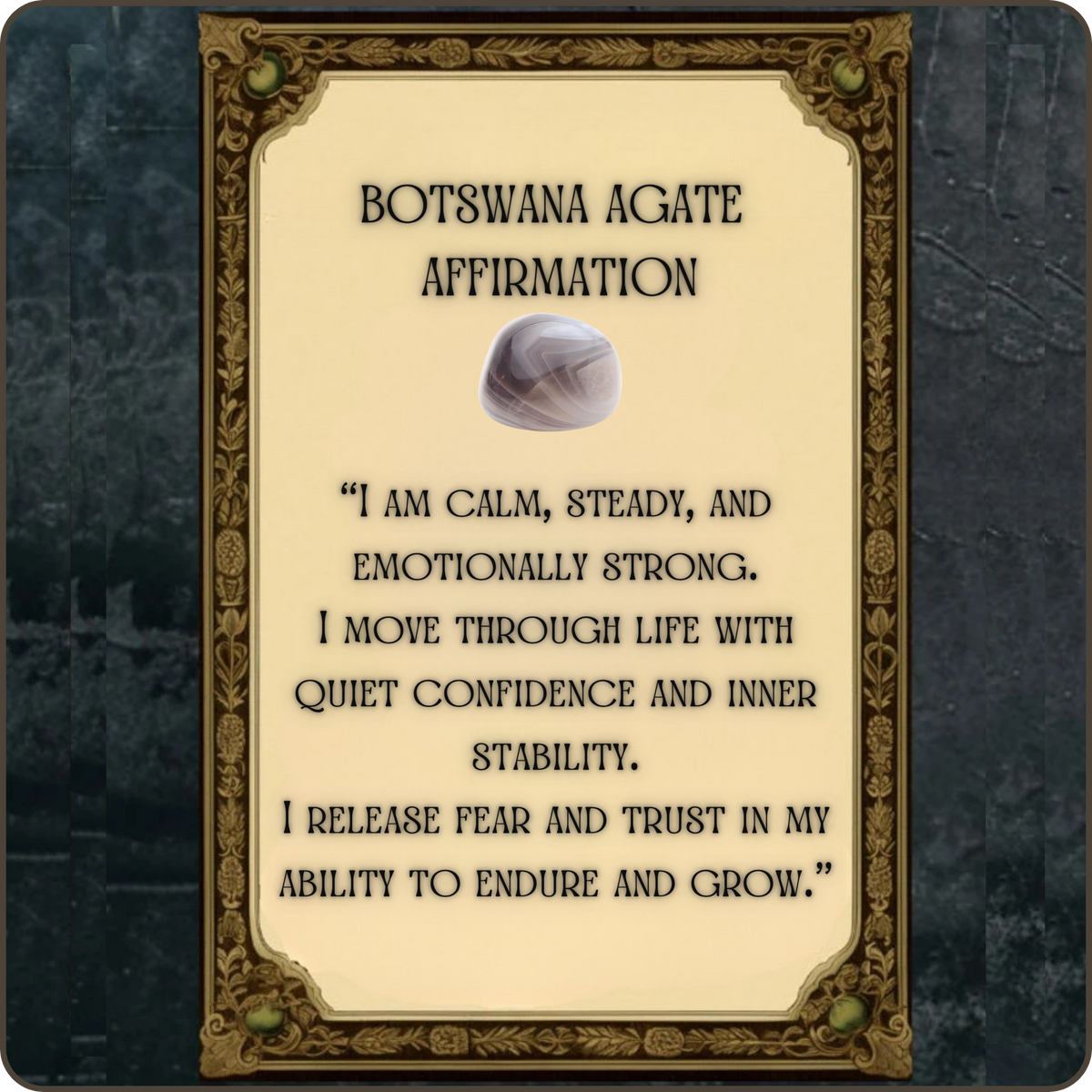 Botswana agate affirmation card with a cream background, black text, and a small agate shell illustration, framed by an ornate gold border against a dark textured backdrop.