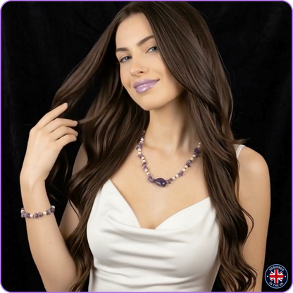 A woman with long wavy brown hair models a matching purple and white beaded necklace and bracelet against a black background.