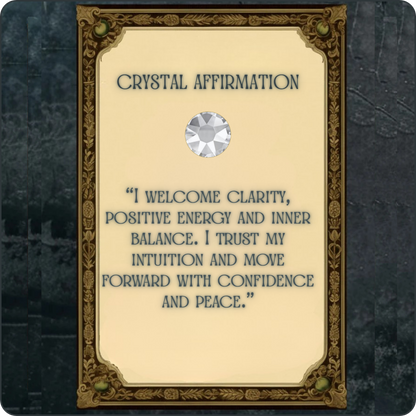 A decorative card or plaque with an ornate gold border and a cream center panel reading “CRYSTAL AFFIRMATION” above a gem illustration and a affirmation quote. The card is centered against a dark textured background.
