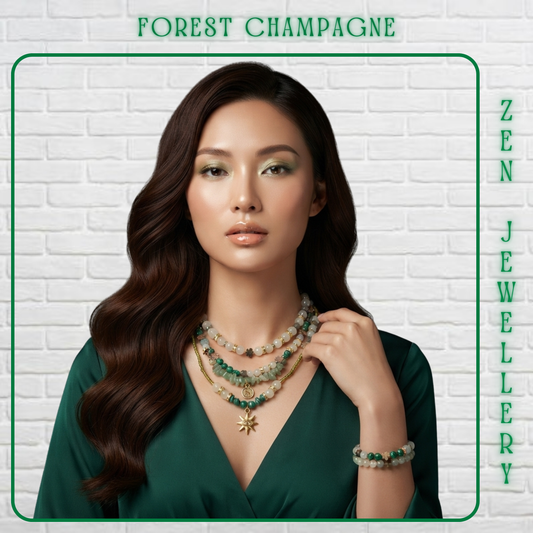 A woman with long wavy brown hair models layered beaded jewelry against a white brick wall background. The jewelry includes a multi-strand necklace with green and cream beads, a gold-toned star pendant, and a matching beaded bracelet.