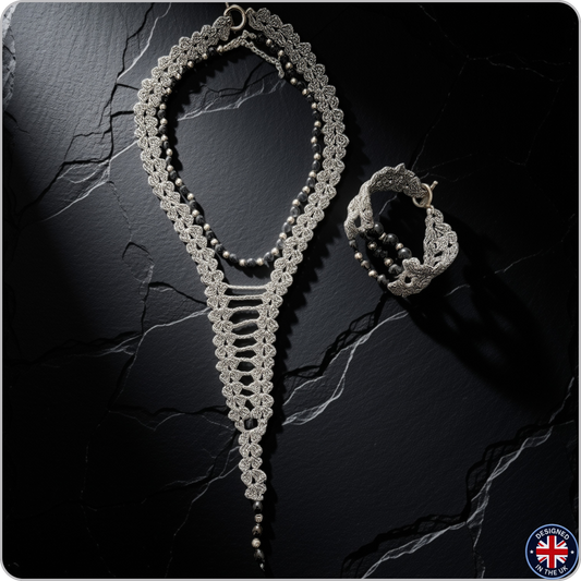 A silver-toned crochet lace jewelry set featuring a long necklace and a matching bracelet, displayed on a dark textured stone surface.