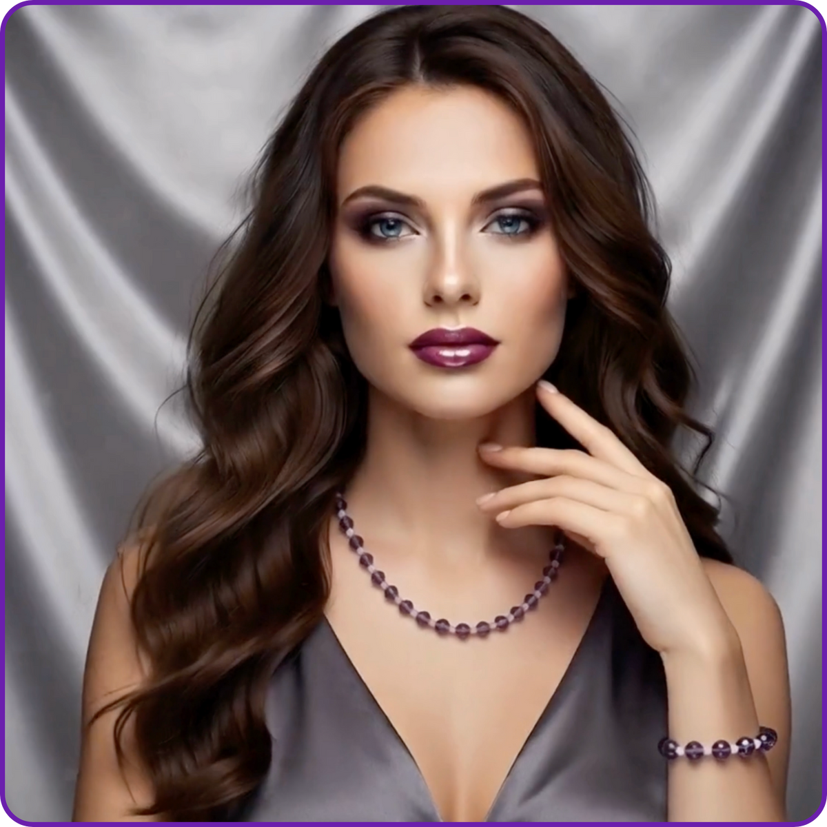 A woman with long wavy brown hair poses against a silver satin backdrop, wearing a matching purple beaded necklace and bracelet.