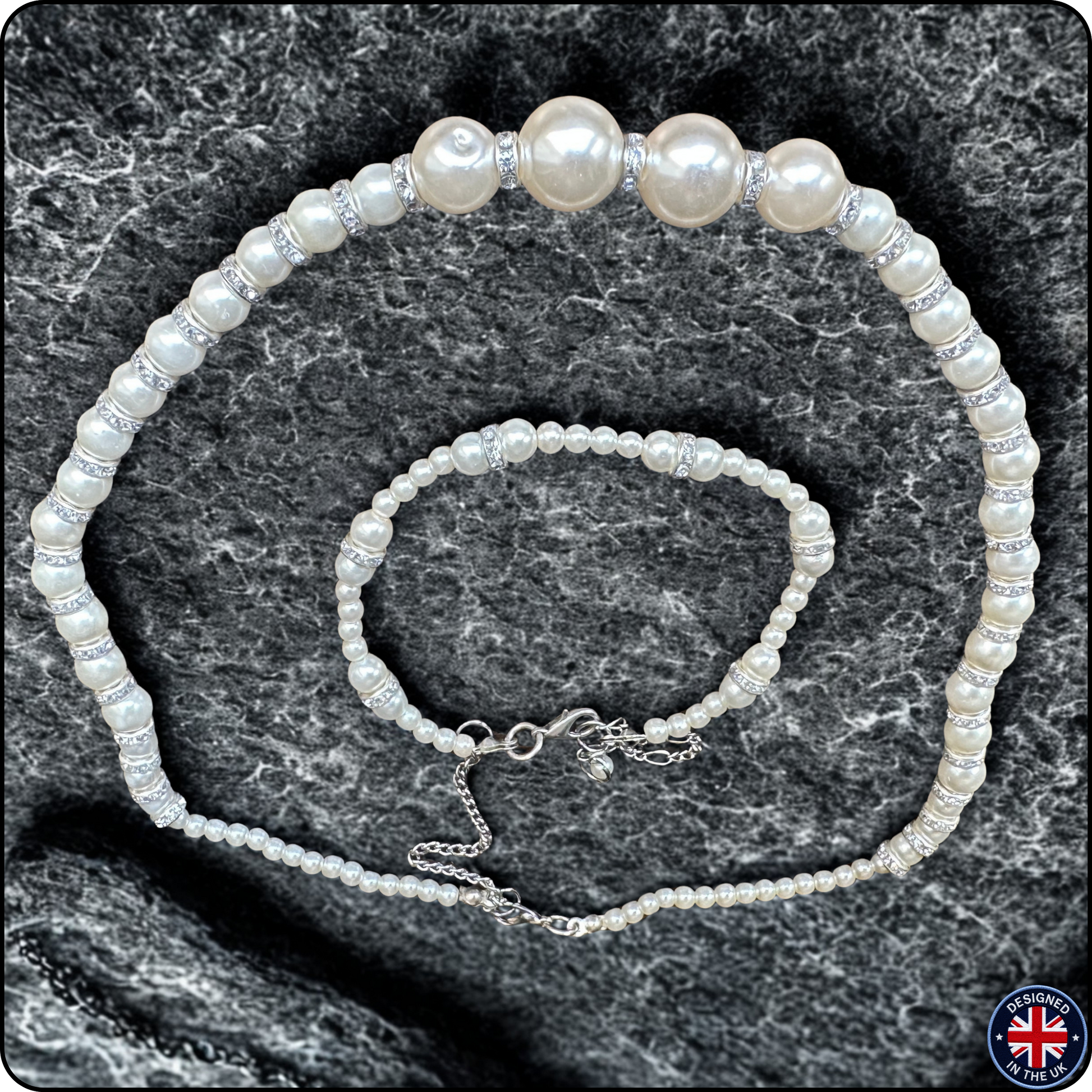 A pearl jewelry set consisting of a choker necklace and a matching bracelet, both featuring white freshwater-style pearls and silver-toned spacer beads, displayed on a dark gray textured stone background.