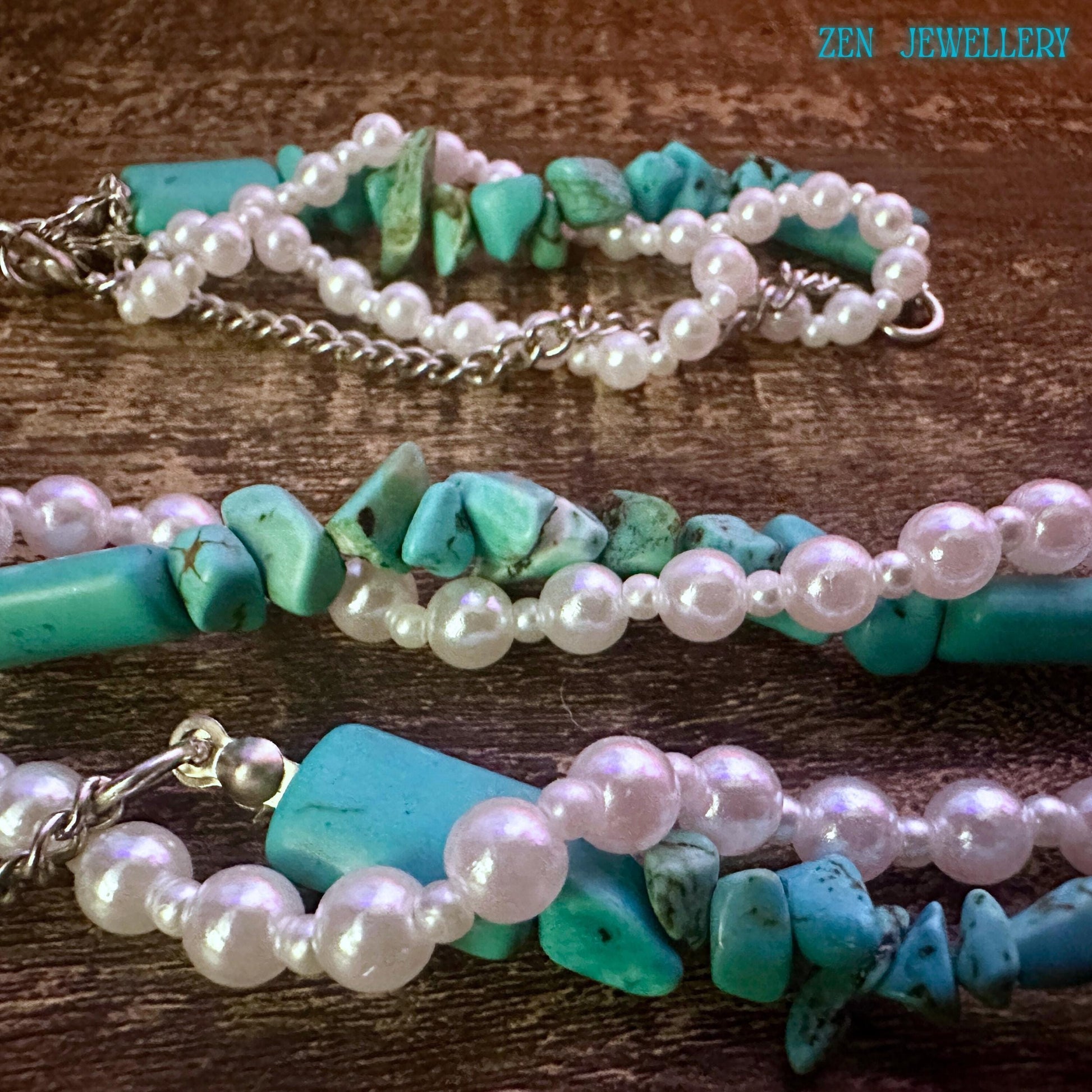 Close-up lifestyle image of turquoise and pearl necklace worn on wood platform, featuring irregular turquoise stones, glossy pearl beads, and a delicate silver chain, with a matching bracelet placed below to show a coordinated handmade set.