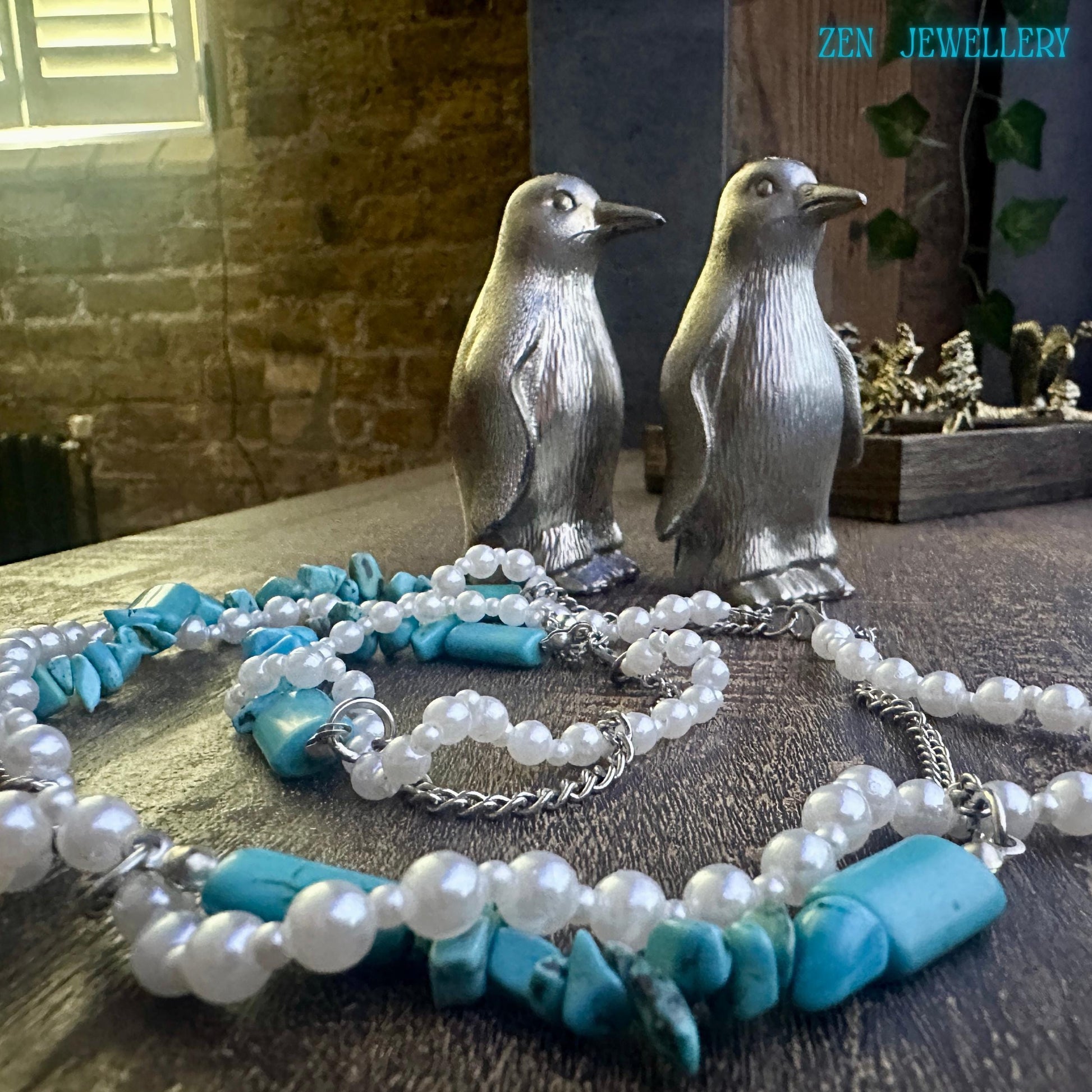 Close-up necklace and bracelet set, featuring turquoise chips and pearl beads, for a calming energy.