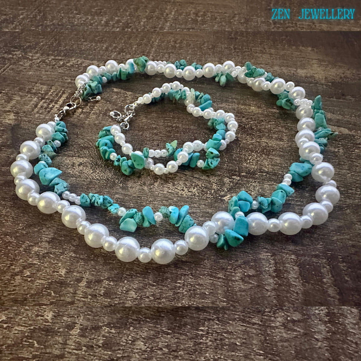 Necklace arranged in oval shape on wooden background showing double strand structure with turquoise chips and pearls, silver clasp placed to the side demonstrating adjustable closure.