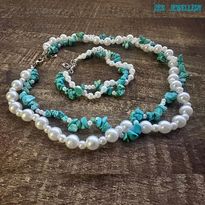 Necklace arranged in oval shape on wooden background showing double strand structure with turquoise chips and pearls, silver clasp placed to the side demonstrating adjustable closure.