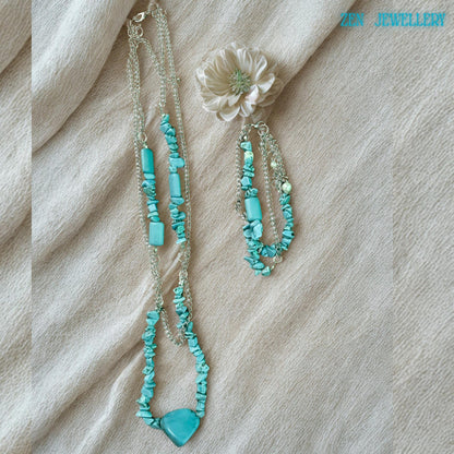 The necklace lay vertically to highlight length and drape, helping buyers visualise how it complements different necklines.
Focus on bead arrangement showing asymmetrical placement typical of handcrafted jewellery, adding uniqueness and artisanal appeal.
Detail of connector rings between chains and beads, showing sturdy construction and thoughtful design.