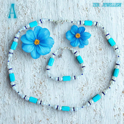 Close-up of the turquoise pearl necklace set highlighting the smooth turquoise beads, round white pearls, blue crystal spacers, and sterling silver clasp mechanism placed on a wooden background to emphasise texture, colour contrast, and the handmade craftsmanship with clear visibility of the adjustable extension chain.
