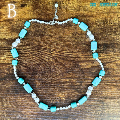This vintage-inspired turquoise necklace features polished turquoise cabochons framed with silver settings and luminous pearl accents arranged in a sophisticated handcrafted composition. The long necklace shape elegantly curves across a rustic wood table, allowing buyers to appreciate the bead sizes, silver clasp detail, and artisan assembly. The statement tassel pendant enhances the western bohemian aesthetic beautifully.
