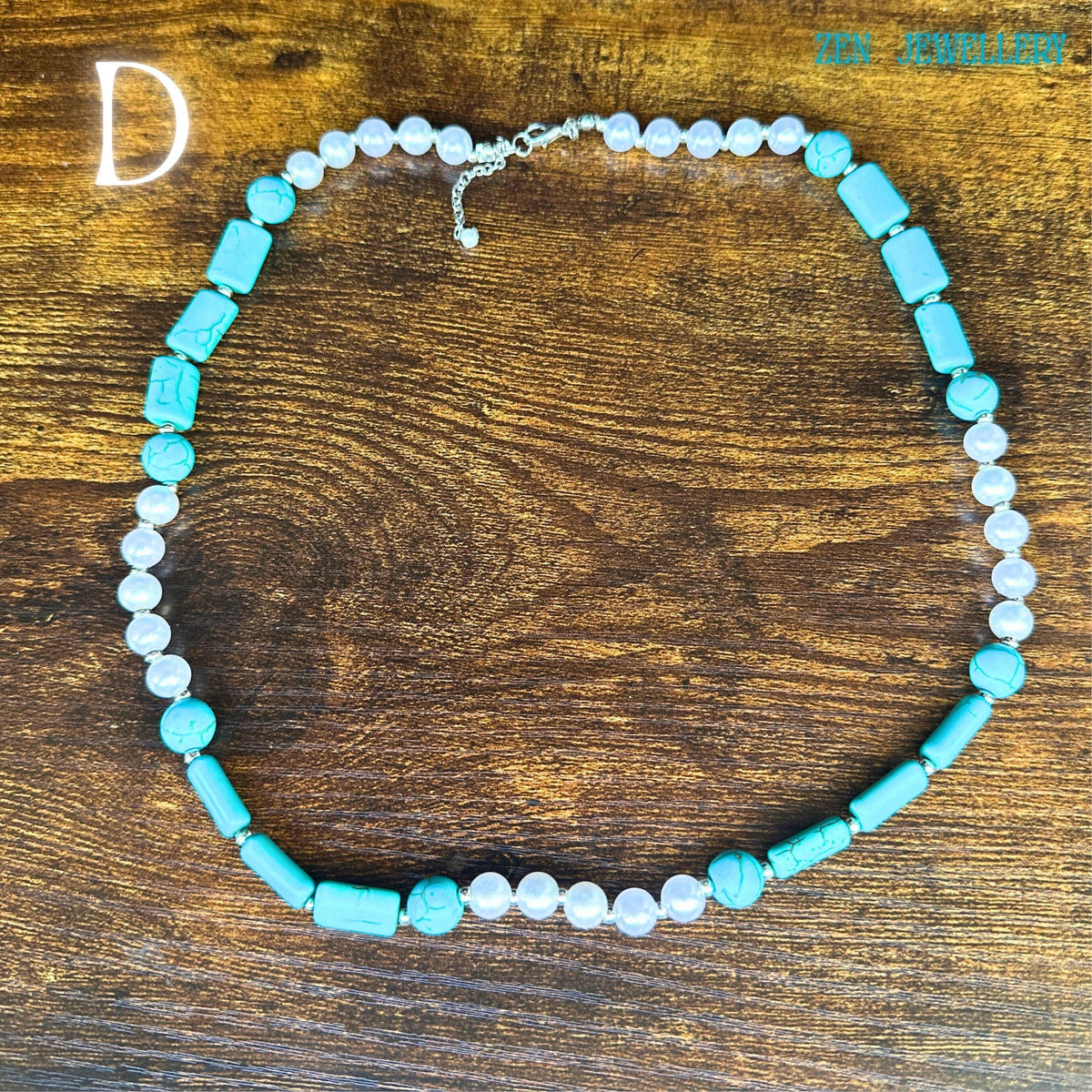 The turquoise and pearl necklace is photographed from above, allowing viewers to appreciate the spacing between beads and the handcrafted symmetry. Smooth pearl beads alternate with vivid turquoise nuggets and silver rhinestone spacers, creating a luxurious bohemian aesthetic. The sterling silver clasp secures the necklace elegantly, while the tassel pendant completes the sophisticated western-inspired design.