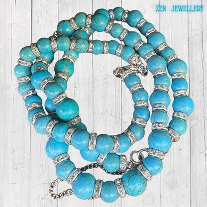 The TURQUOISE rhinestone jewellery set is photographed from above to showcase the coordinated necklace and bracelet design. Bright turquoise gemstone beads contrast beautifully with the shimmering rhinestone spacers, while the rustic wood background adds warmth and vintage character to the handcrafted jewellery presentation.