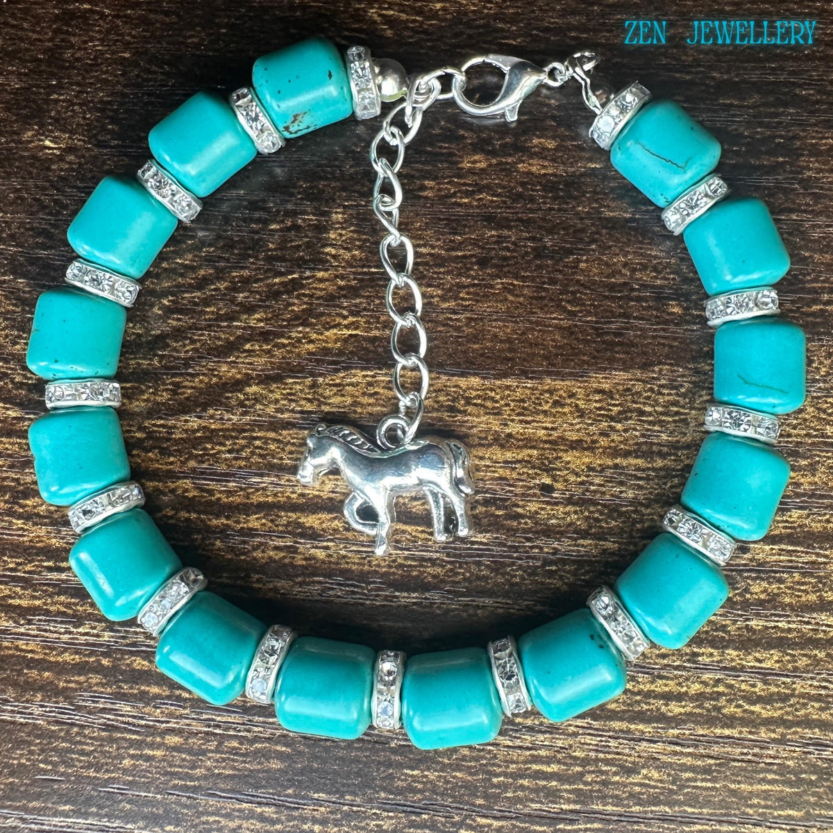 Elegant bohemian turquoise bracelet with chunky blue-green beads and crystal rhinestone spacers creating beautiful sparkle against the polished silver hardware and modern western-inspired styling.