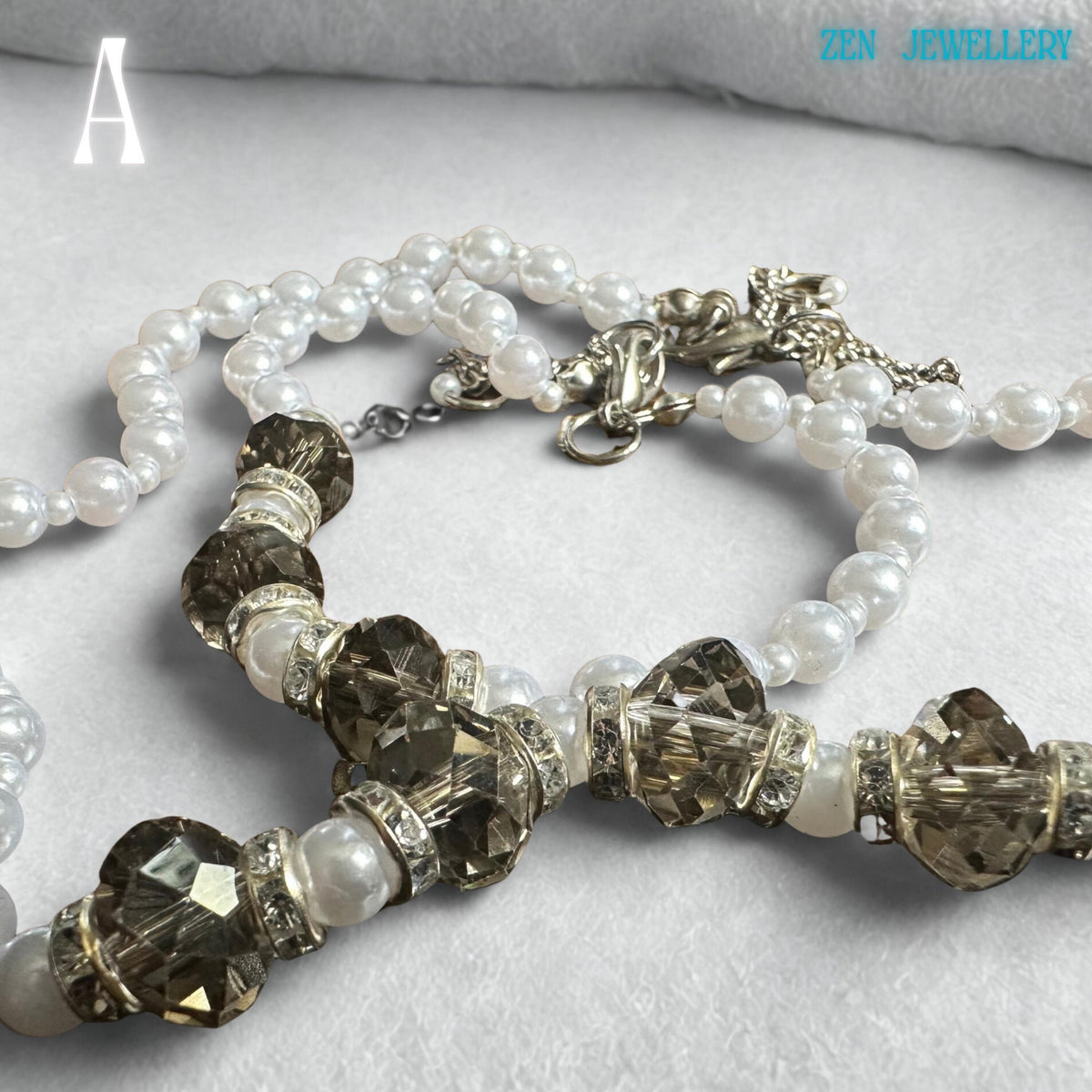 Close-up white pearl necklace with shimmering transparent Austrian crystals layered on a delicate silver chain, boho chic style. the perfect gift for a wedding or an anniversary.