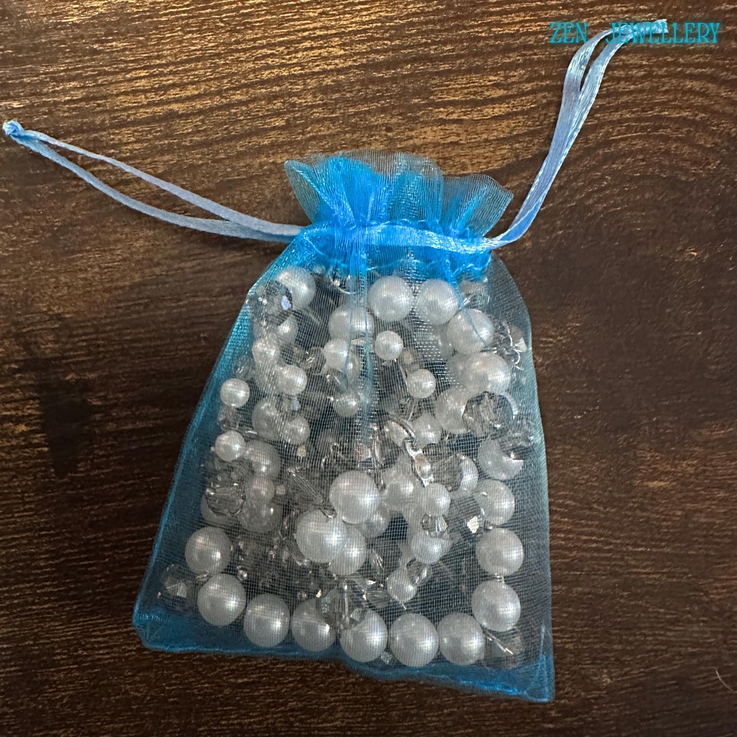 Sparkling Austrian crystals and white pearls on a silver chain necklace, styled for fashion-forward women in a gift bag from Zen Jewellery