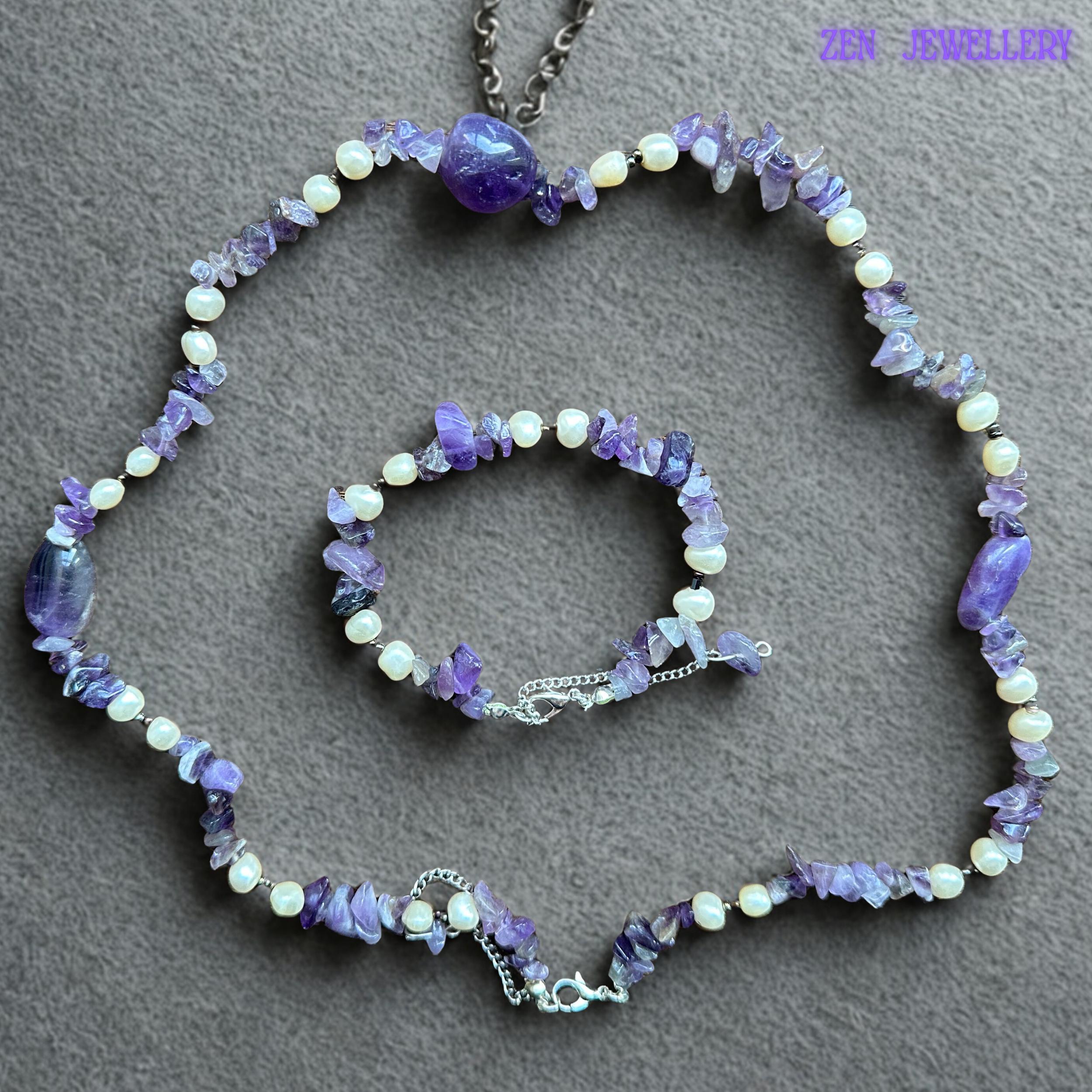 Detailed image showing polished lavender-purple gemstone focal beads surrounded by irregular natural amethyst crystal chips and ivory pearl accents. The silver extension chain and clasp create an adjustable handmade finish suitable for everyday wear or layered boho styling.