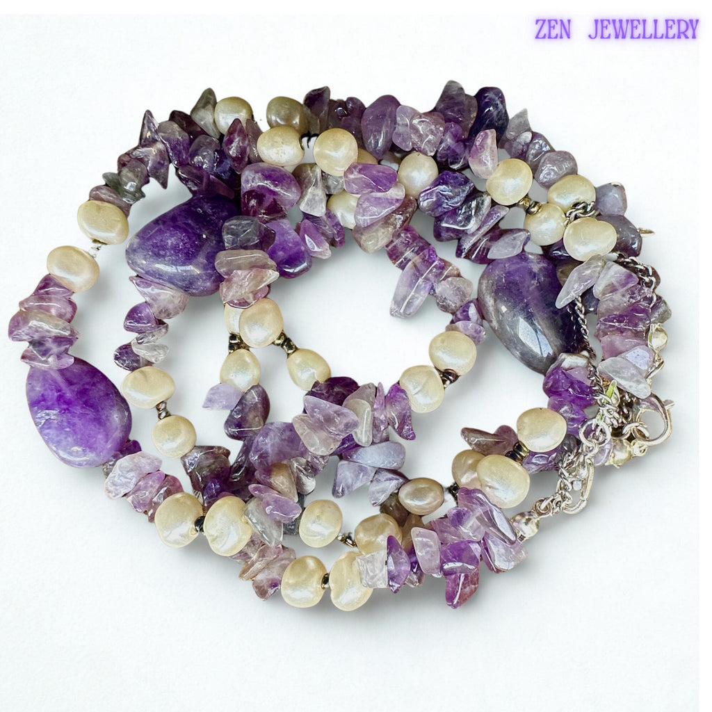 • The polished amethyst-style gemstone beads create luxurious shine and calming purple tones throughout the necklace and bracelet set. Small creamy pearl accents soften the design and create elegant contrast while silver clasp details complete the lightweight handmade jewellery style.