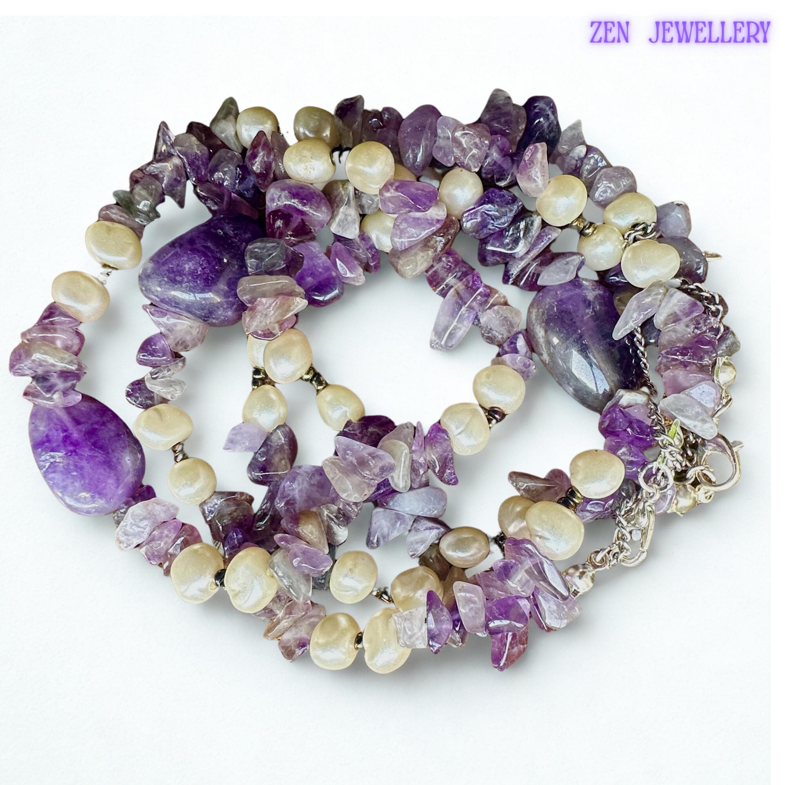 • The polished amethyst-style gemstone beads create luxurious shine and calming purple tones throughout the necklace and bracelet set. Small creamy pearl accents soften the design and create elegant contrast while silver clasp details complete the lightweight handmade jewellery style.