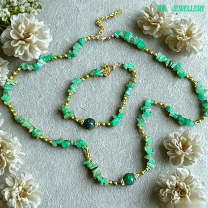 Handmade African jade and aventurine jewellery set with gold clasp and extender chain. • Elegant handmade necklace with layered green gemstone chips reflecting light softly while gold chain accents create a luxurious feminine bohemian look. Natural green aventurine chip necklace displayed with matching bracelet showing detailed gemstone textures, polished surfaces, and delicate gold connectors.