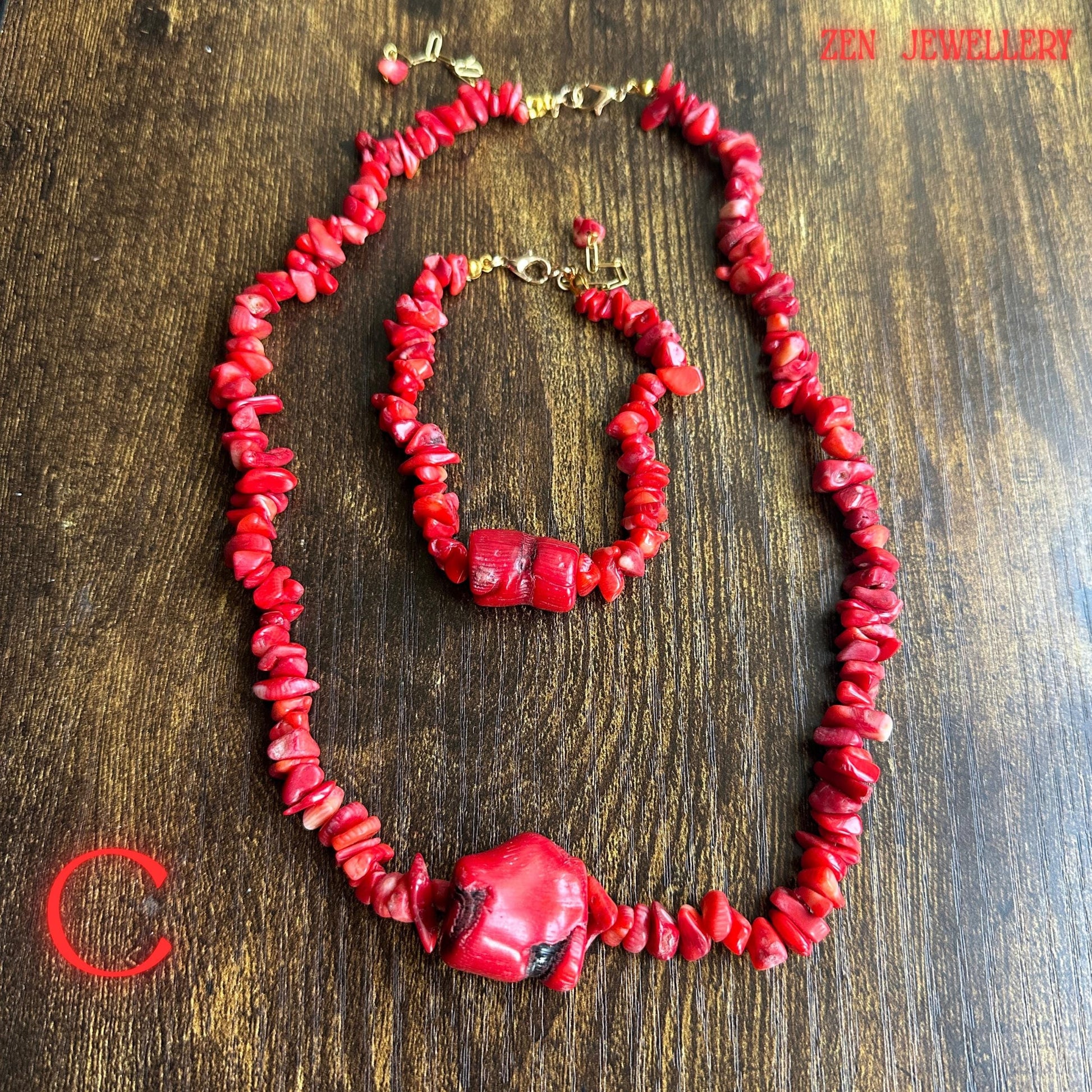Full view of the red coral jewellery set featuring layered coral chips with polished natural-style surfaces and bright red tones. The matching bracelet mirrors the necklace design beautifully creating a cohesive artisan jewellery set ideal for bohemian outfits and summer fashion styling.