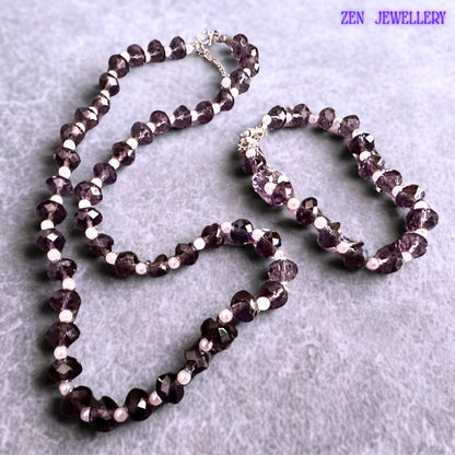 Matching purple crystal bracelet and necklace set designed with faceted lavender beads creating texture sparkle and elegant movement paired with white pearl accents and silver extension chains for adjustable comfortable wear.