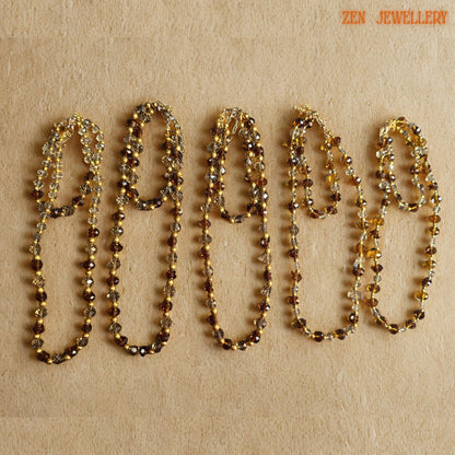 Close-up image of polished faceted AUSTRIAN CRYSTAL beads showing intricate cut surfaces, warm amber reflections, and elegant gold spacer bead details. The necklace and bracelet are carefully handcrafted to create lightweight, comfortable jewellery with luxurious visual sparkle. Elegant caramel crystal necklace paired with matching bracelet featuring golden bead accents and delicate clasp details designed for feminine evening fashion and glamorou