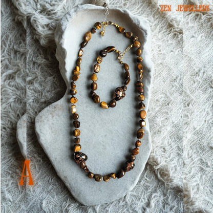 Elegant boho jewellery set featuring natural tiger eye stones in caramel, brown, and golden shades with polished gold spacer beads and secure gold clasps. The matching handmade necklace and bracelet create a coordinated, earthy, luxurious style for lightweight, comfortable wear.