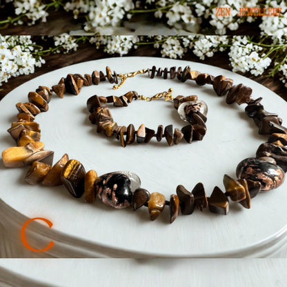 Handmade tiger eye necklace and bracelet set with glossy polished beads, warm honey tones, and gold metallic accents, creating a luxurious handmade accessory. The natural gemstone shine and delicate chain details give the jewellery timeless feminine elegance.