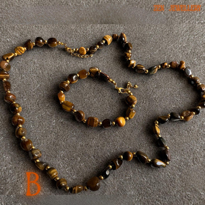 Handmade tiger eye jewellery with polished gemstone beads reflecting warm golden light and natural earthy tones. The rich caramel and honey shades pair beautifully with gold chain details, creating a timeless and feminine bohemian fashion accessory.