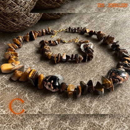 Rich brown tiger eye stones with golden banding create a soft reflective effect in this elegant handmade jewellery set. The polished gemstone beads are paired with gold spacer beads and matching gold clasps for a coordinated boho luxury style.