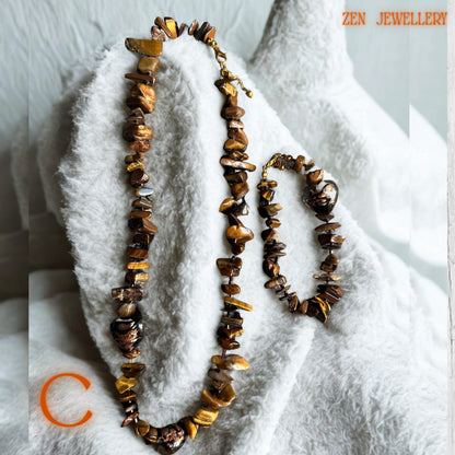 Lightweight tiger eye jewellery set featuring smooth brown gemstone beads and elegant gold chain links. The handmade necklace and bracelet create a stylish earthy fashion look perfect for casual outfits, evening wear, or layered jewellery styling.