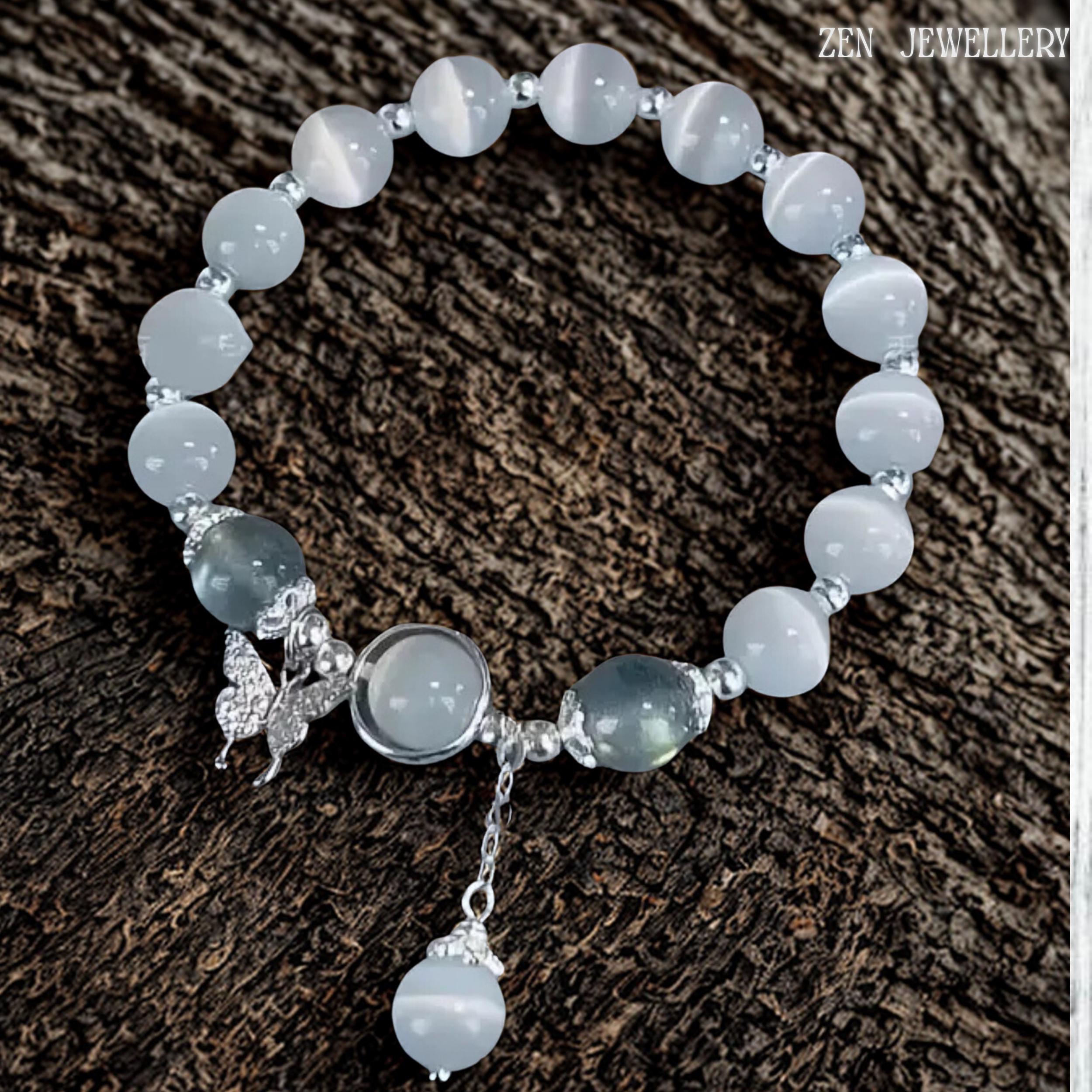 Artistic close-up displaying the butterfly charm suspended beside the central gemstone setting, showcasing intricate metal detailing and graceful silhouette while complementing the surrounding white gemstone beads, creating a romantic and feminine jewellery design suitable for bridal styling, anniversary celebrations and meaningful gifting occasions.