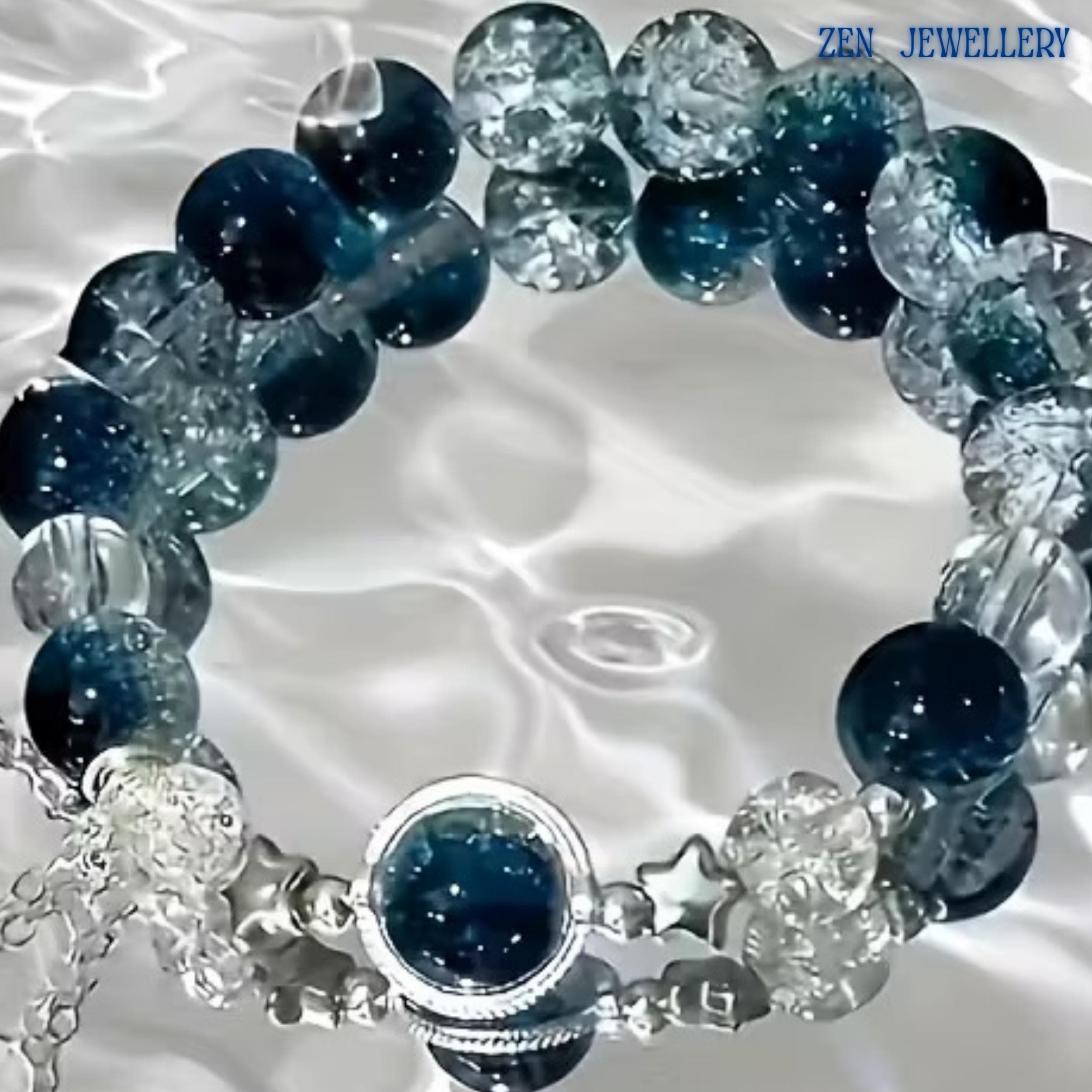 Detailed close-up of the silver star charm accents positioned near the centre gemstone. The stars symbolise hope, guidance, and inspiration while complementing the ocean-inspired colour palette. The polished silver finish reflects light beautifully and adds a celestial element to the bracelet’s sophisticated handcrafted design.