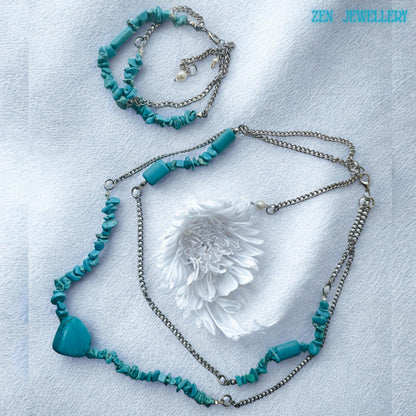 Close-up of the turquoise heart pendant showing smooth polished surface and subtle natural veining, adding a focal point to the necklace design with a soft bohemian romantic touch.