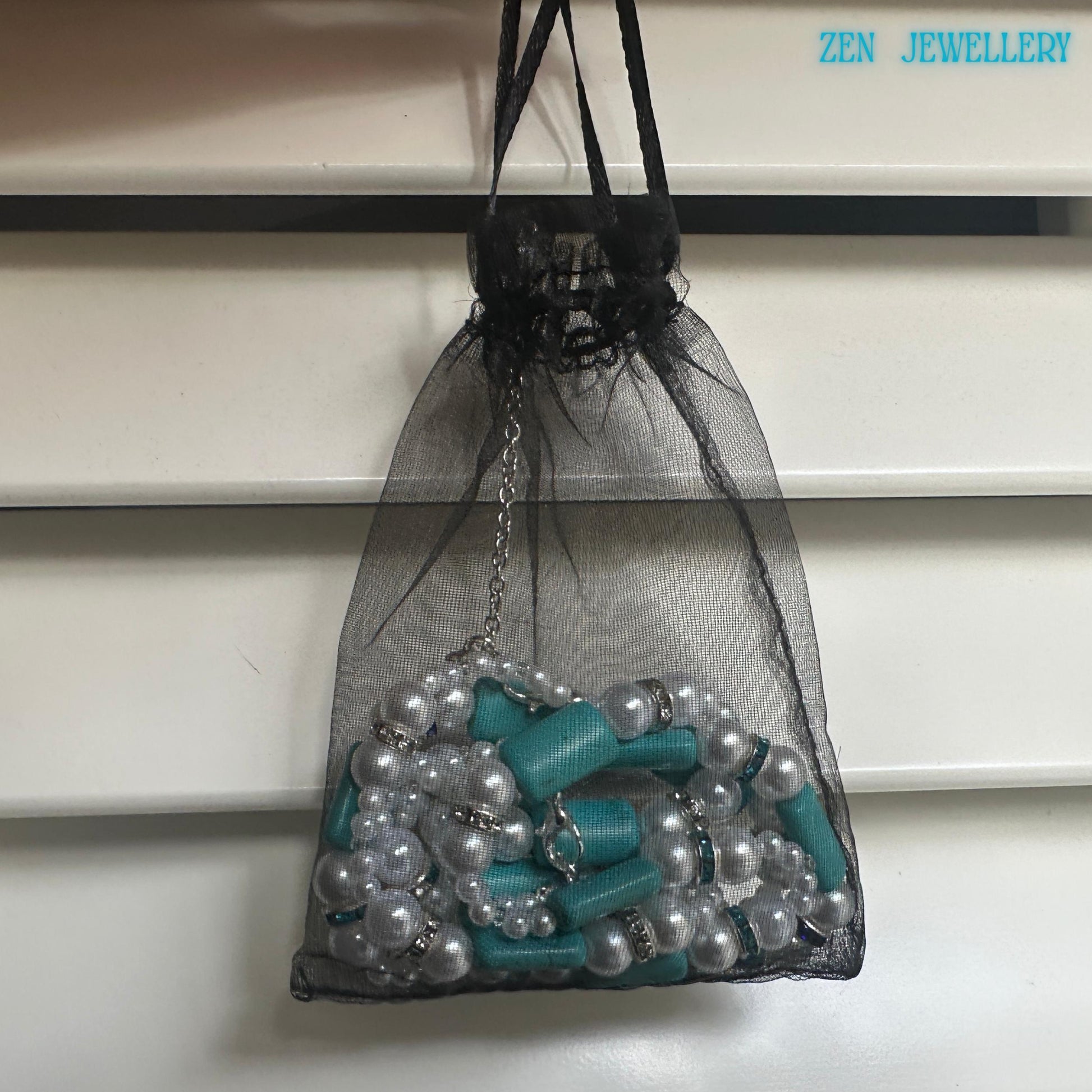 A full view of the turquoise pearl jewellery set showing the necklace and bracelet positioned together to highlight the matching design of turquoise beads and pearl elements with blue rhinestone spacers and sterling silver clasps emphasising the cohesive handmade turquoise jewelry style.