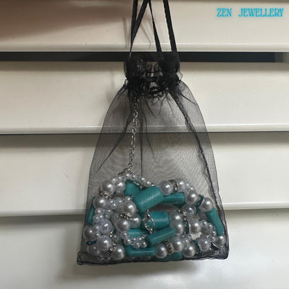 A full view of the turquoise pearl jewellery set showing the necklace and bracelet positioned together to highlight the matching design of turquoise beads and pearl elements with blue rhinestone spacers and sterling silver clasps emphasising the cohesive handmade turquoise jewelry style.