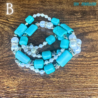 The TURQUOISE PEARL necklace is shown with layered curves emphasising the handcrafted beadwork and elegant boho chic accessories styling. Bright turquoise nuggets contrast with soft white pearl beads and shimmering silver connectors, creating a balanced artistic composition. The rustic wood surface enhances the earthy bohemian mood, while the sterling silver clasp adds premium quality detail.