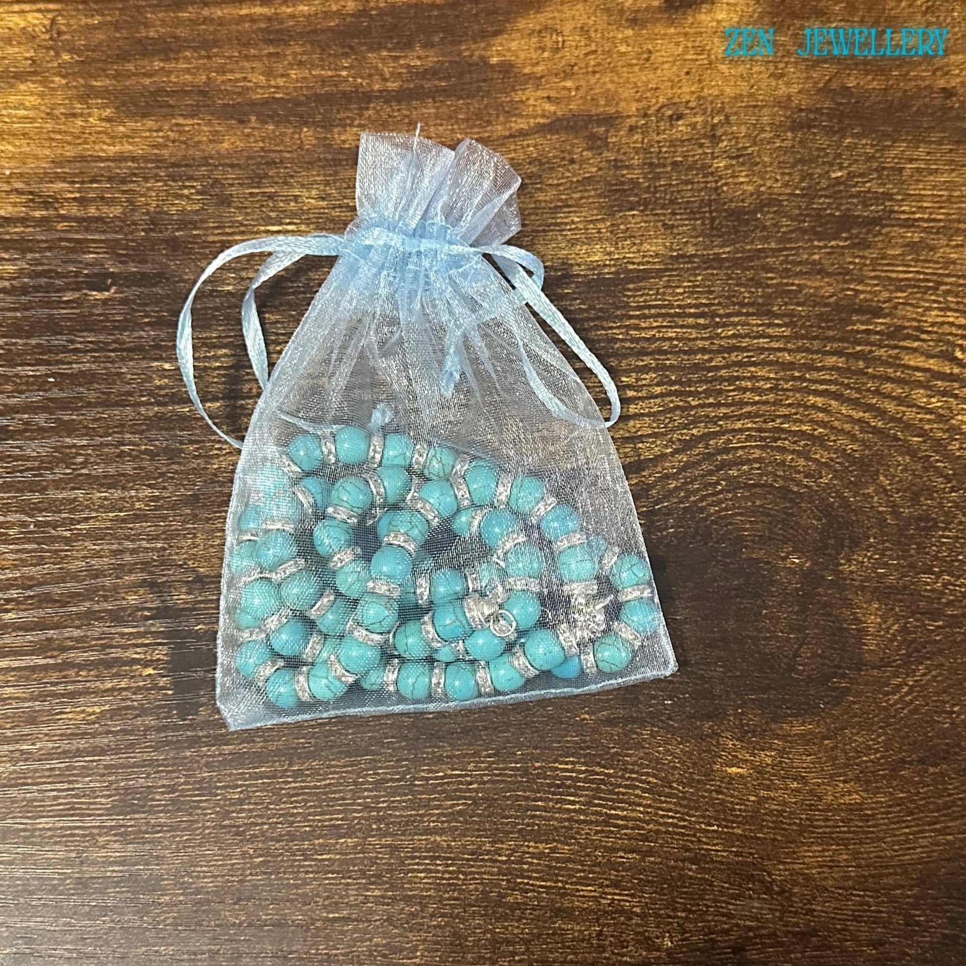 An elegant artisan jewellery set featuring handcrafted turquoise beads in multiple sizes, accented with rhinestone spacer details and sterling silver findings. The necklace measures approximately 45 cm, and the bracelet measures 20 cm, making the set perfect for comfortable everyday boho chic styling. Gift-ready turquoise and rhinestone necklace bracelet set in packaging with a soft fabric bag.
