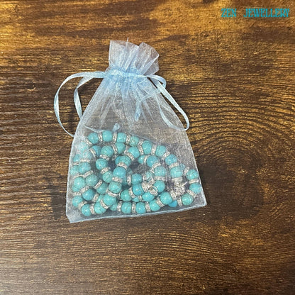 An elegant artisan jewellery set featuring handcrafted turquoise beads in multiple sizes, accented with rhinestone spacer details and sterling silver findings. The necklace measures approximately 45 cm, and the bracelet measures 20 cm, making the set perfect for comfortable everyday boho chic styling. Gift-ready turquoise and rhinestone necklace bracelet set in packaging with a soft fabric bag.