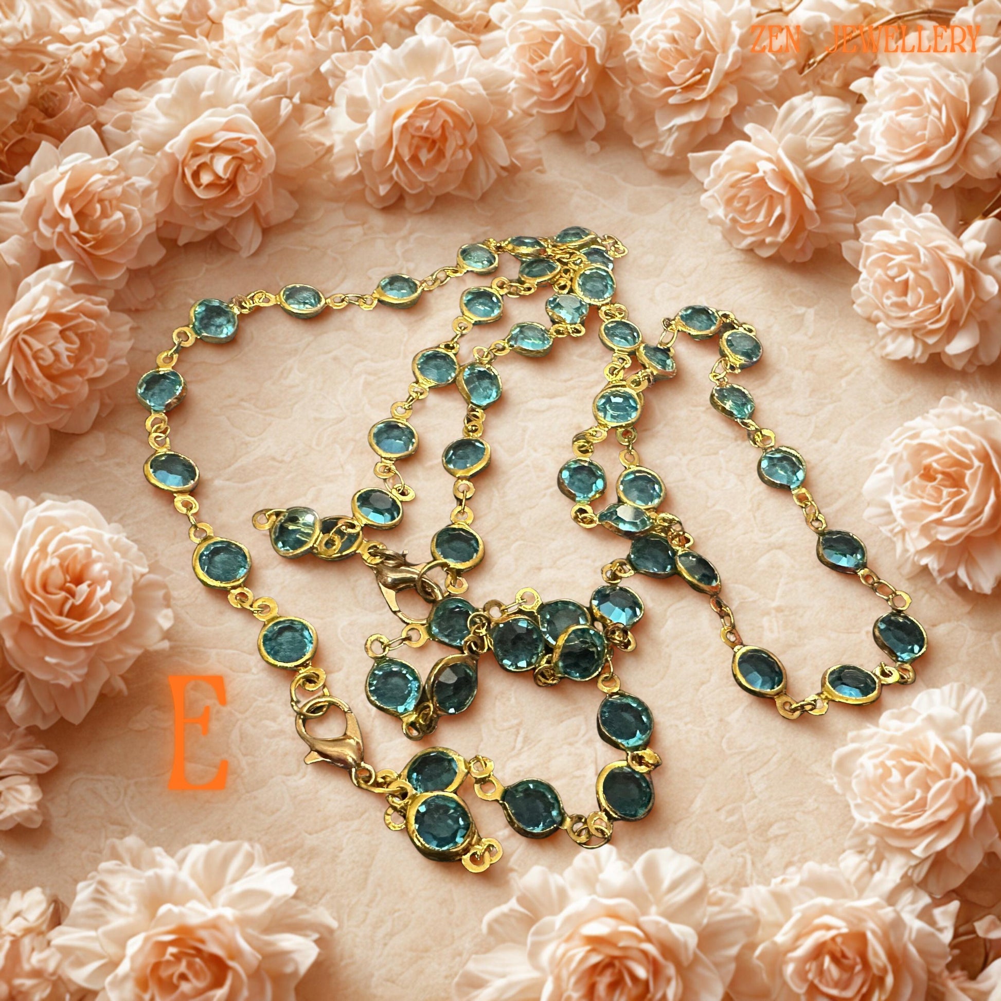 Emerald green crystal jewellery set featuring faceted stones linked with vintage inspired gold chain and subtle rhinestone details. The sparkling green gemstones reflect light beautifully and create botanical elegance inspired by natural luxury and romantic garden styling. Coordinated necklace and bracelet provide versatile styling options for elegant fashion, festive celebrations, or meaningful handmade gifting.