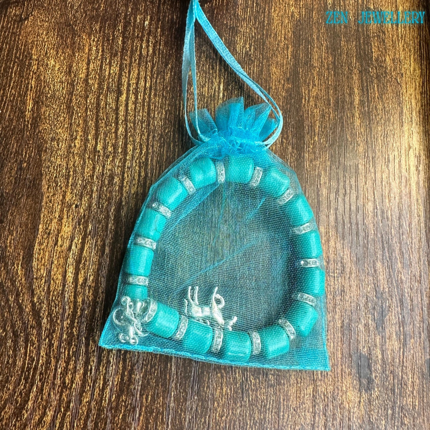 Natural turquoise cylinder beaded bracelet with detailed horse charm in a gift bag