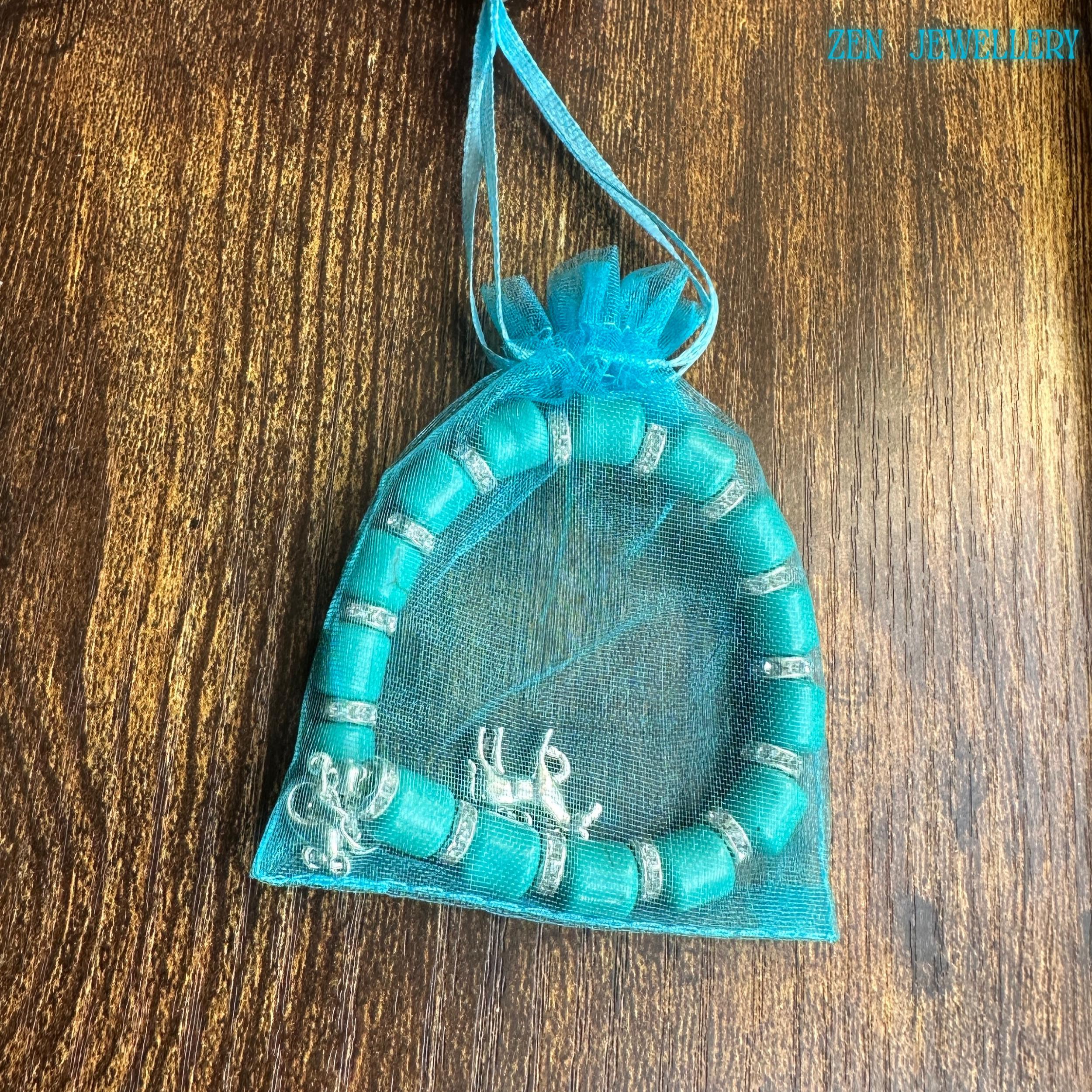 Natural turquoise cylinder beaded bracelet with detailed horse charm in a gift bag