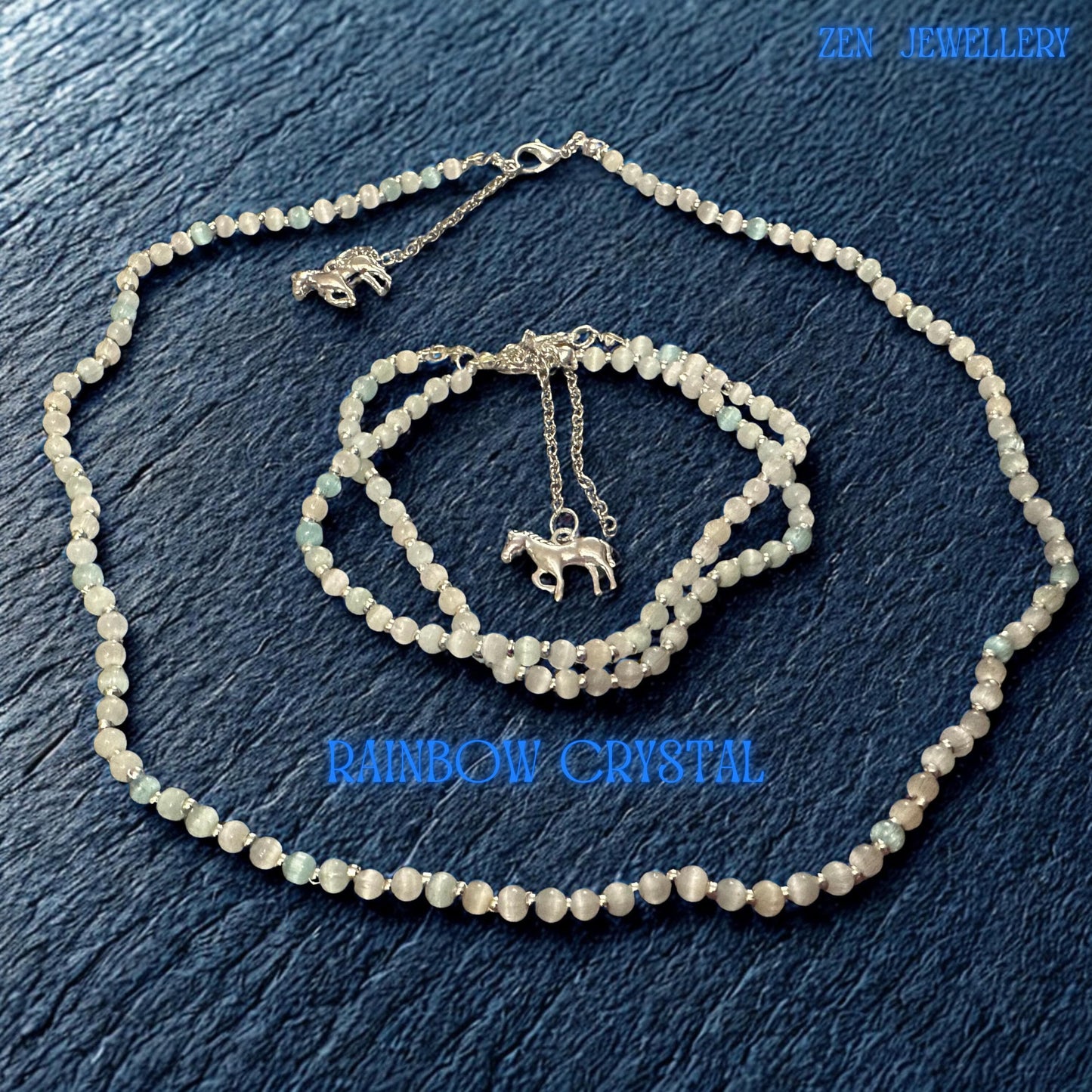 Full jewellery set photographed from above showing the necklace and two matching bracelets arranged together. The pale white crystal beads contrast beautifully against the dark textured surface, allowing buyers to clearly see bead size, spacing, sterling silver components and overall proportions. Adjustable fittings provide versatile sizing and comfortable wear.