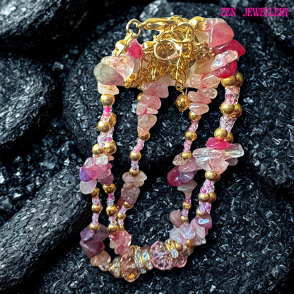 Luxury bohemian wrap bracelet featuring multiple strands of pink gemstones, including soft blush tones, rose pink, and raspberry hues. Each strand is accented with shimmering crystal beads and gold-tone details that add a refined sparkle. The bracelet wraps elegantly around the wrist, creating a layered stacked effect. This handcrafted piece is perfect for those who love feminine, romantic jewellery with a natural gemstone aesthetic and artisan c