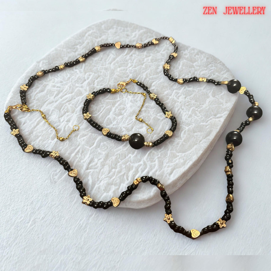Several larger round black agate beads serve as focal elements within the necklace and bracelet design. These statement stones add depth, dimension, and luxury while maintaining a cohesive appearance with the smaller surrounding beads. The photograph captures the smooth rounded shapes and glossy finish of the gemstones, allowing buyers to visualize the premium quality and elegant character of the handcrafted jewellery.