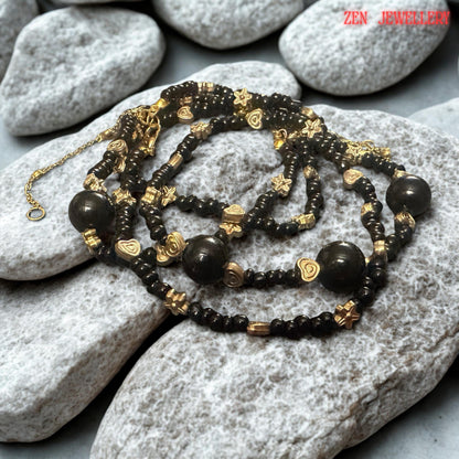 Intricate floral spacer beads add delicate decorative detail throughout the jewellery set. Their gold-tone finish complements the black agate gemstones while introducing texture and artisanal character. The close positioning of these accents throughout the necklace and bracelet creates a cohesive design that feels both elegant and handcrafted, making the set suitable for gifting, celebrations, or personal jewellery collections.