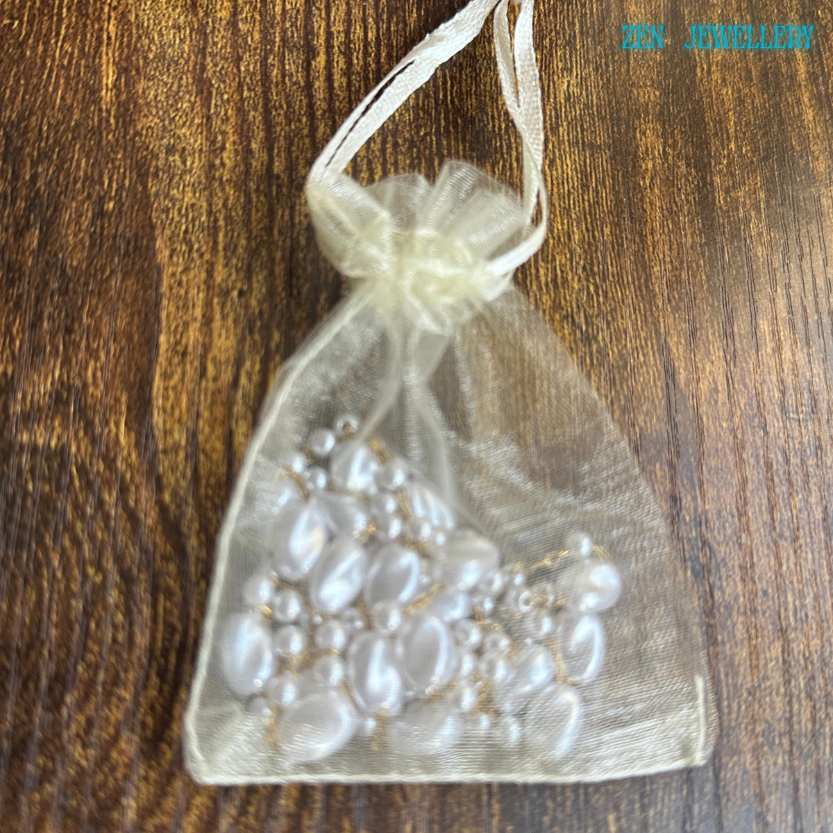 Handmade minimalist necklace with white pearls on gold chain, perfect for layering or solo statement.