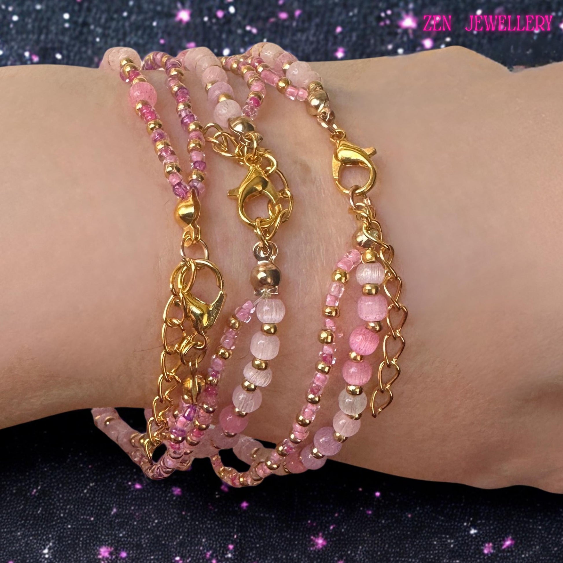 The handcrafted design features a combination of polished rose crystal beads, shimmering rhinestone details, and coordinated metallic accents. Soft blush pink tones dominate the bracelet, creating a romantic and feminine aesthetic suitable for everyday styling or special occasions. The central raspberry pink bead introduces bold contrast and visual interest while maintaining a cohesive colour palette throughout the design.