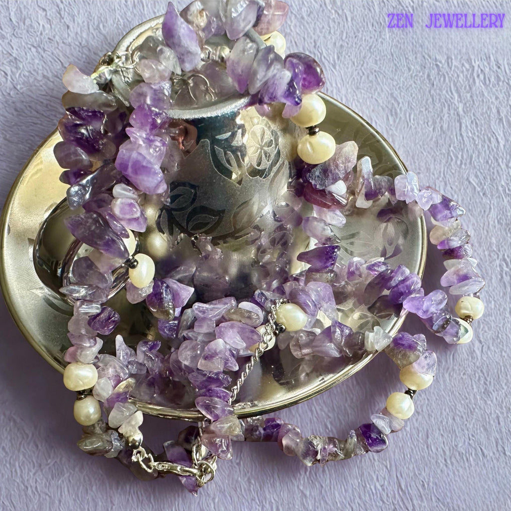 • This feminine handmade jewellery set combines polished purple gemstone beads, natural crystal chips, creamy pearls, and silver clasp details in a graceful bohemian design. The coordinated necklace and bracelet create elegant layered texture and lightweight comfortable wear.